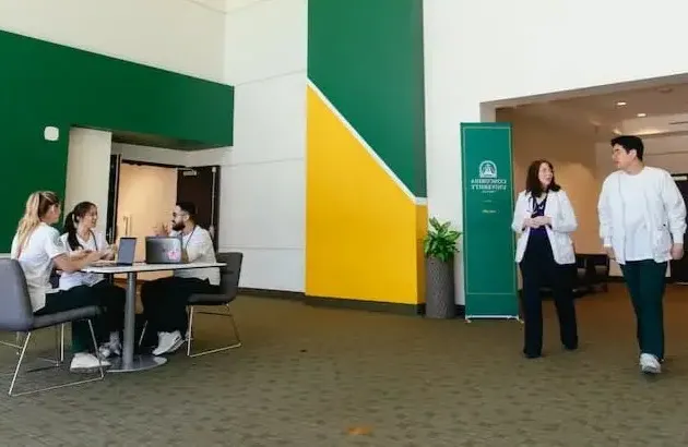 护理 students and faculty in new building hallway